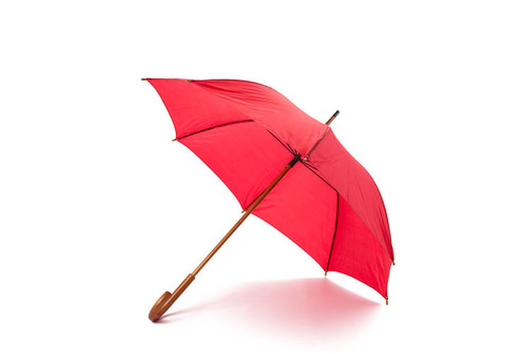 白い背景に置かれた赤い傘